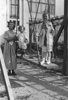 Irina, Yuliy and Vera Briner with nanny Katya in the courtyard of a house on Svetlanskaya St, 1923. Creator: Unknown.