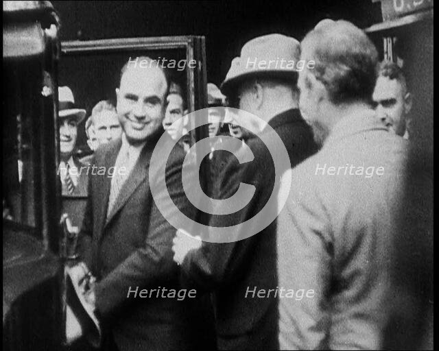 Alphonse Gabriel Capone AKA 'Al Capone' Entering a Car Watched by a Small Crowd, 1930. Creator: British Pathe Ltd.