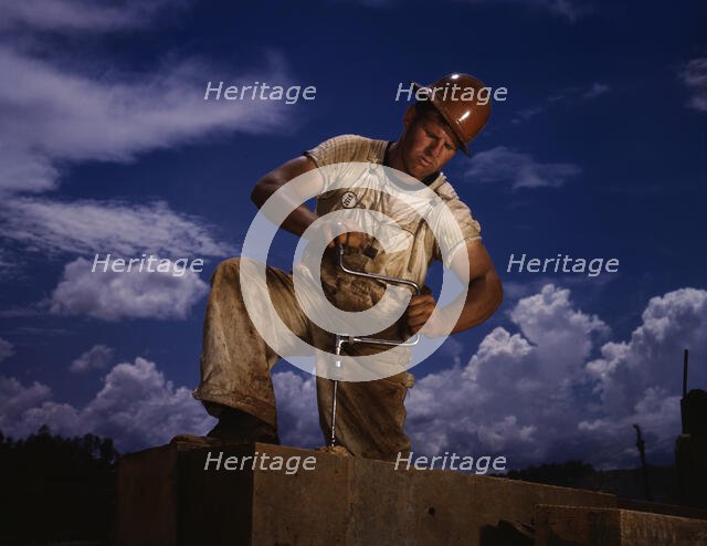 A carpenter at the TVA's new Douglas dam on the French Broad River, Tenn., 1942. Creator: Alfred T Palmer.