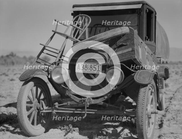 Car of drought refugee on edge of carrot field in the Coachella Valley, California, 1937. Creator: Dorothea Lange.