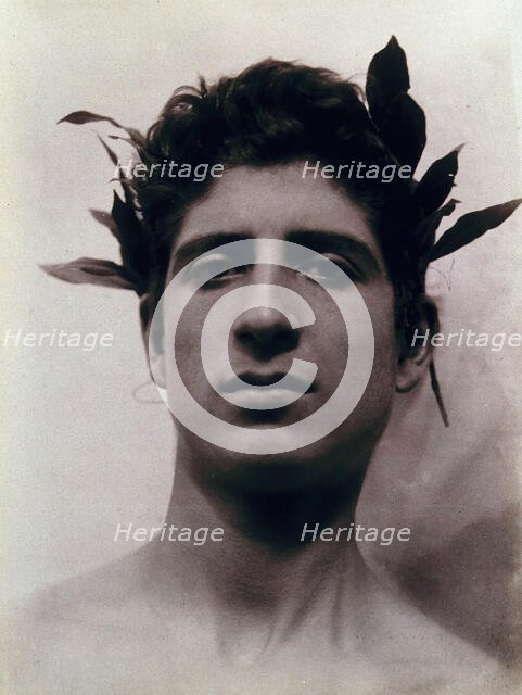 Head of a Sicilian boy posing, crowned with laurel leaves, March 1902. Creator: Count Wilhelm von Gloeden.
