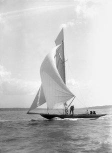 The 8 Metre 'Termagant' sailing with spinnaker, 1911. Creator: Kirk & Sons of Cowes.