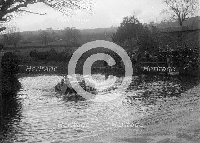 972 cc Singer Le Mans driving through a ford during a motoring trial, 1936. Artist: Bill Brunell.