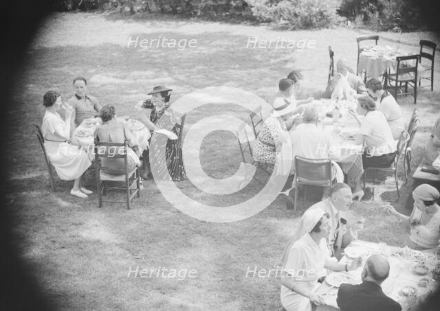 Mrs. Mary Benson and others, seated outdoors, between 1933 and 1942. Creator: Arnold Genthe.