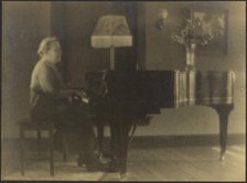 Portrait of a Woman Seated at the Piano, 1895-1907. Creator: Louis Fleckenstein.