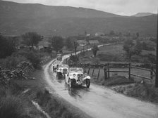 Two Singer Le Mans cars competing in the RSAC Scottish Rally, 1936. Artist: Bill Brunell.