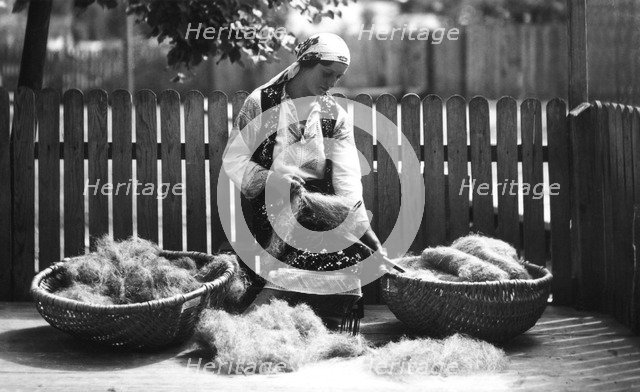 Woman with baskets of wool, Bistrita Valley, Moldavia, north-east Romania, c1920-c1945. Artist: Adolph Chevalier