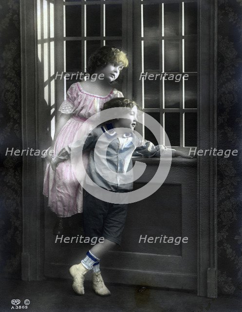 Brother and sister by a window, Sweden, c1900. Artist: Unknown