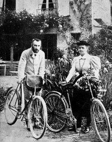 Pierre and Marie Curie, French physicists, preparing to go cycling. Artist: Unknown