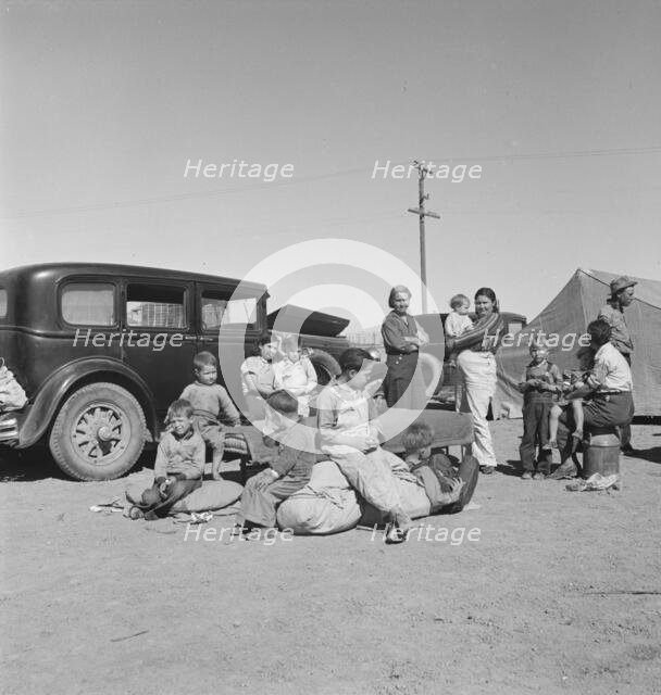 Families from the Dust Bowl in Texas in an overnight roadside camp near Calipatria, California, 1937 Creator: Dorothea Lange.