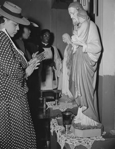 Worshipper before the altar of the St. Martin's Spiritual Church, Washington, D.C., 1942. Creator: Gordon Parks.