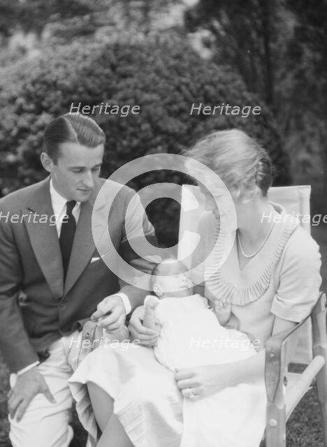Brady, James Cox, Jr., Mr. and Mrs., and child, seated outdoors, 1930 May 24. Creator: Arnold Genthe.