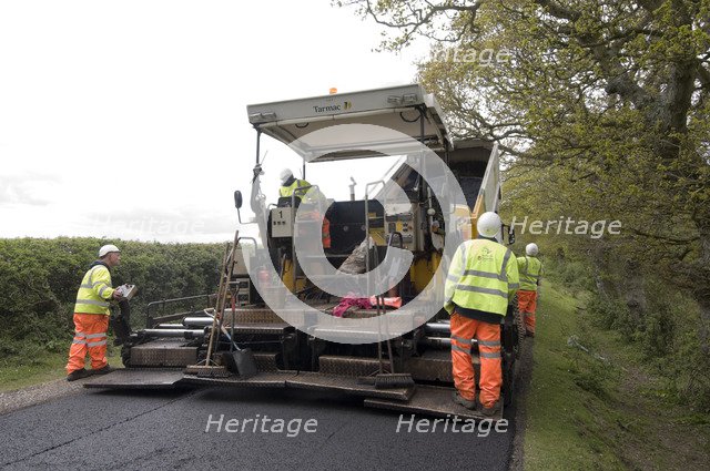 Road resurfacing work repairing potholes Artist: Unknown.