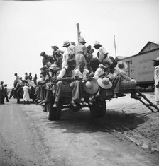 Peach pickers being driven to the orchards, Muscella, Georgia, 1936. Creator: Dorothea Lange.