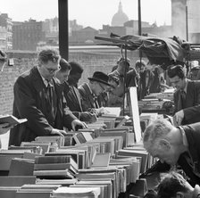 A row of men browse an open air second hand bookseller's stall, Finsbury, London, c1946-c1959. Artist: John Gay