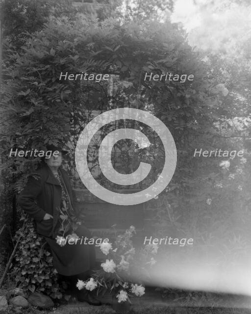 Frances Benjamin Johnston, photographer, posed sitting with peonies..., Takoma Park, Maryland, 1938. Creator: Unknown.