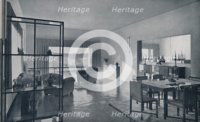 'Paniconi and Pediconi. A dining room with a large window and curtains designed to frame a beautiful Artist: Unknown.