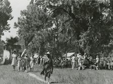 African Americans walking in an open field at a picnic, Beaufort, South Carolina, July 4, 1939. Creators: Farm Security Administration, Marion Post Wolcott.