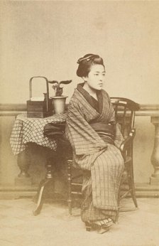 Woman sitting by table, about 1868. Creator: Felice Beato.