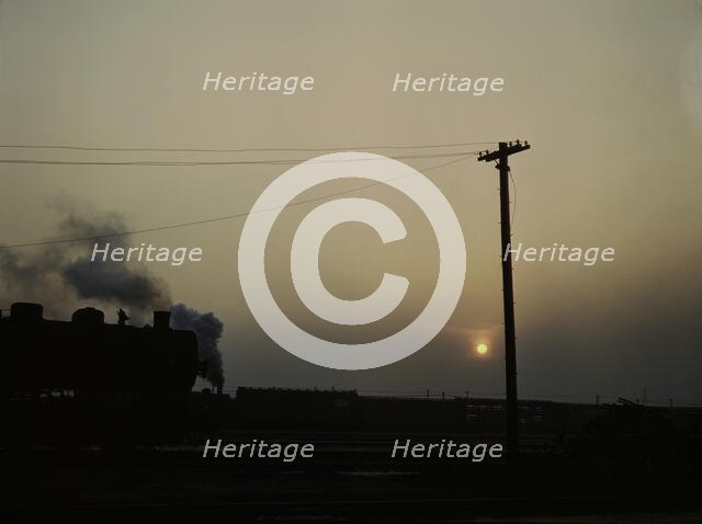 View in a departure yard at C & NW RR's Proviso (?) yard at twilight, Chicago, Ill., 1942. Creator: Jack Delano.
