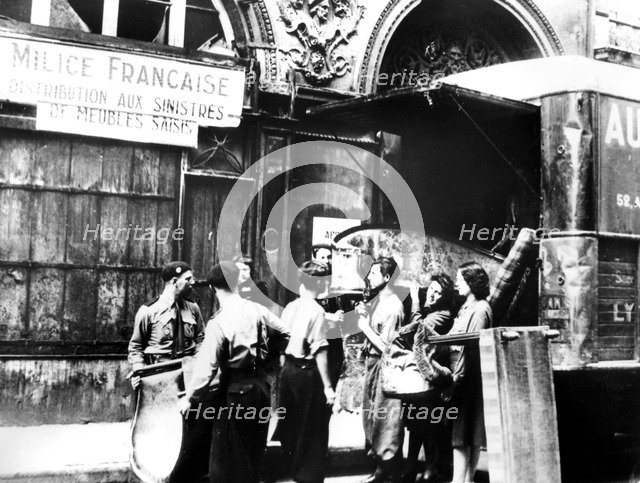 Distributing furniture confiscated from Jews to victims of Allied bombing, Paris, 1943-1944. Artist: Unknown