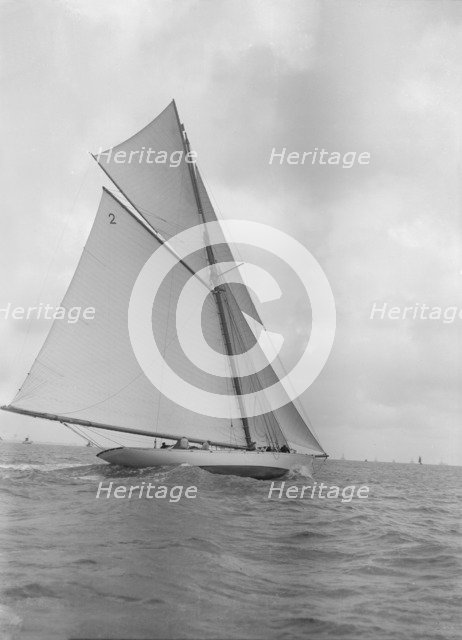 The 40-rater cutter 'Carina' sailing close-hauled, 1911. Creator: Kirk & Sons of Cowes.