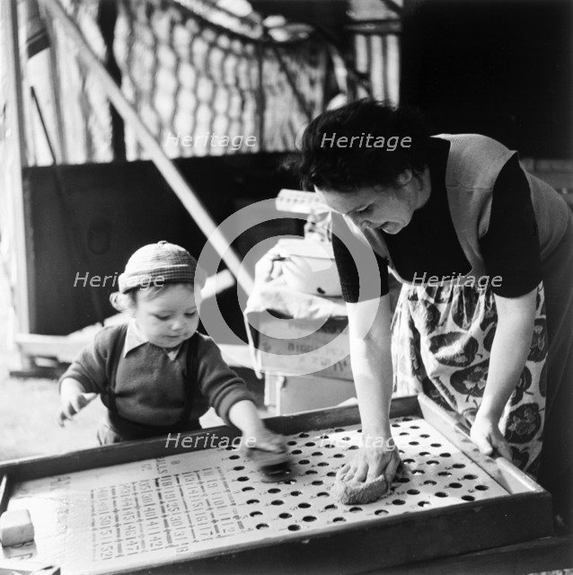 Woman and child at Hampstead fun fair, London, (early 1950s?). Artist: Henry Grant