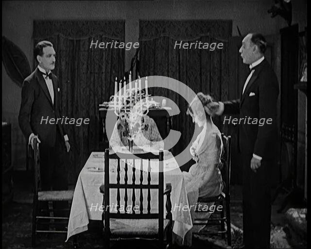 Scene from a 1920s Film. A Group of Actors Playing an Upper Class Family Sitting Down at..., 1920s. Creator: British Pathe Ltd.