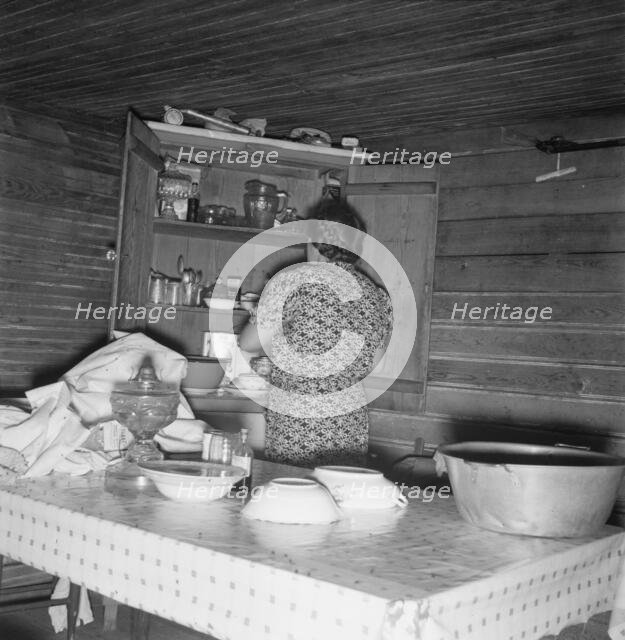 Wife of tobacco sharecropper putting breakfast dishes away. Person County, North Carolina, 1939. Creator: Dorothea Lange.