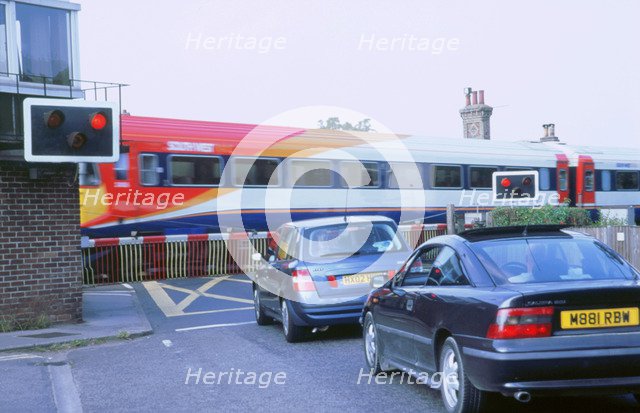 Traffic queue at level crossing in Brockenhurst, Hampshire. Artist: Unknown.