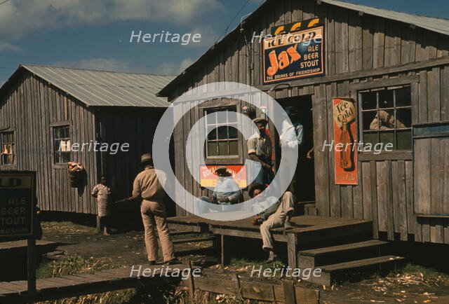 Living quarters and "juke joint" for migratory workers, a slack season; Belle Glade, Fla., 1941. Creator: Marion Post Wolcott.