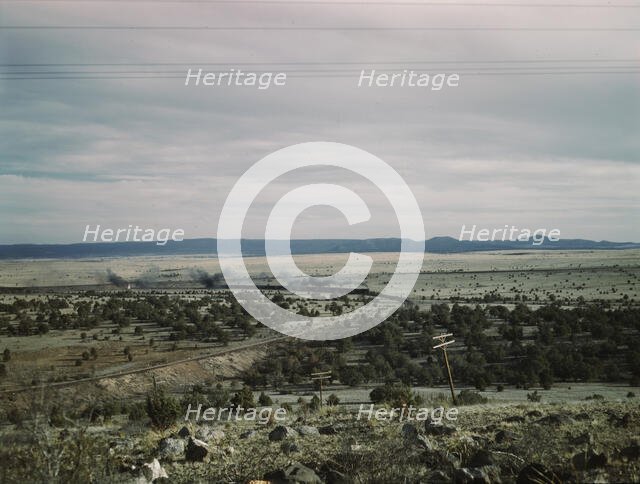 West-bound passenger train going around a curve on the Atchison..., near Gleed, Arizona, 1943. Creator: Jack Delano.