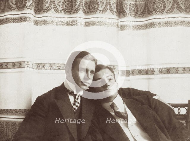 Two men resting close to one another, wearing formal attire, 1910. Creator: Unknown.