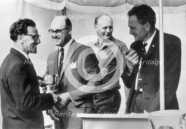 Murray Walker in 1963, Lord Montagu in background. Creator: Unknown.