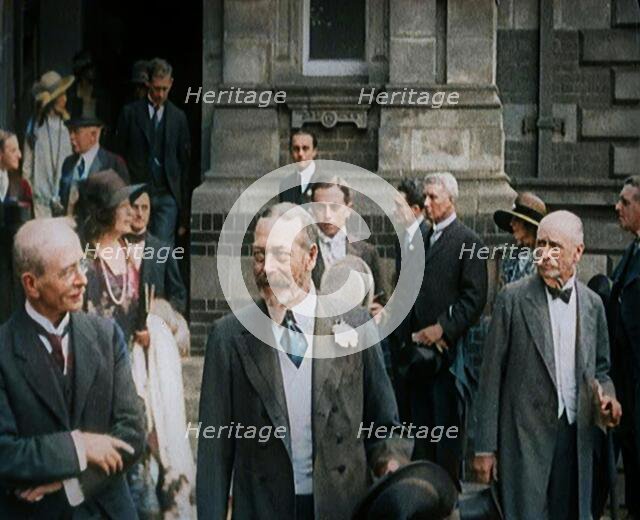 King George V Accompanied by a Group of Officials Emerging from a Building , 1924. Creator: British Pathe Ltd.