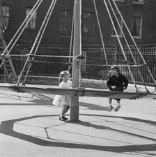 Girls playing on a 'witch's hat' in a playground, London, 1960-1965. Artist: John Gay
