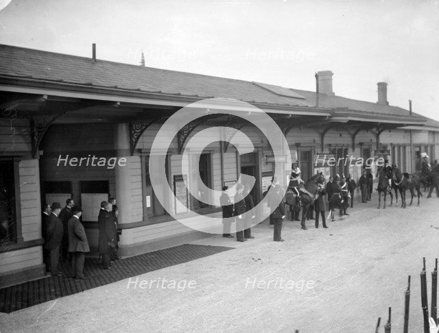 Group, including soldiers and policemen, wait outside Oxford Railway Station, Oxon, c1860-c1922. Artist: Henry Taunt
