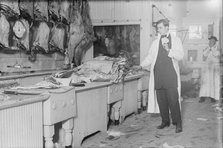 Butcher stands idle before his counter of meat during the meat boycott, 1910. Creator: Bain News Service.