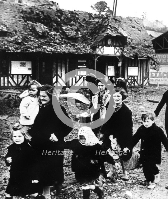 Families leaving their village bombarded during the Normandy landings, France, 1944. Artist: Unknown