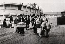 Immigrants to the USA landing at Ellis Island, New York, c1900. Artist: Unknown