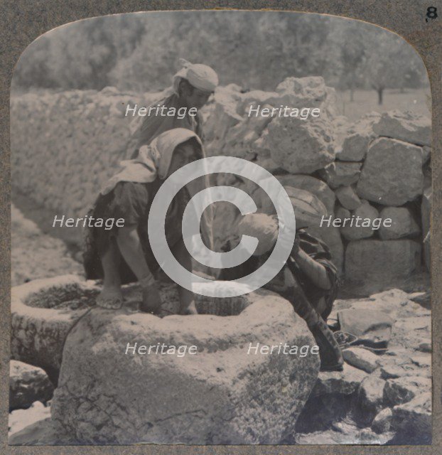 'Women drawing water at the Fountain of the Magi, on the road to Bethlehem', c1900. Artist: Unknown.