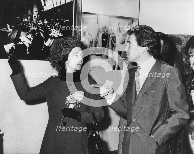 The Queen and Lord Snowdon discussing his pictures, Ideal Home Exhibition, Olympia, London, 1973. Artist: Unknown