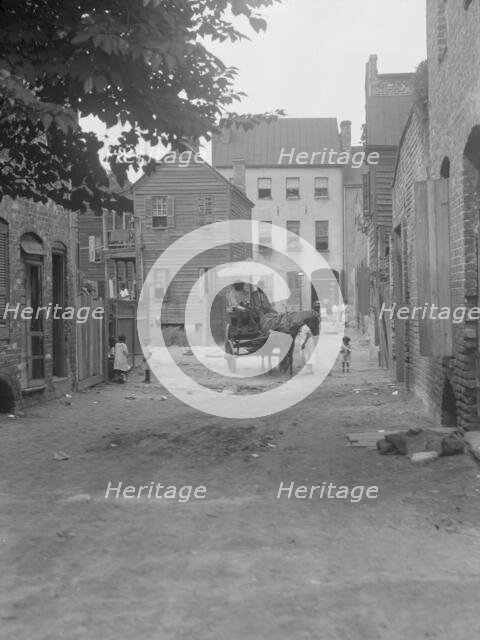 Street scene - looking north on Bedons Alley to Elliott Street; with horse and wagon..., c1920-1926. Creator: Arnold Genthe.