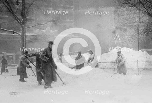 Shovelling snow in City Hall Park, New York, 1910. Creator: Bain News Service.