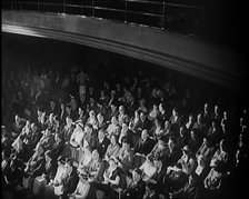 A Crowd of People Watching Acrobats on Stage in a Theatre, 1931. Creator: British Pathe Ltd.