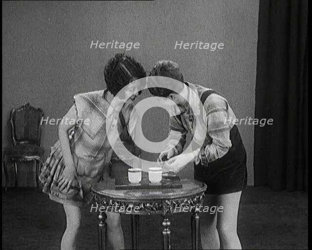 Billie Houston Showing Her Sister Renee Houston Some New Gags With Matches, 1920s. Creator: British Pathe Ltd.