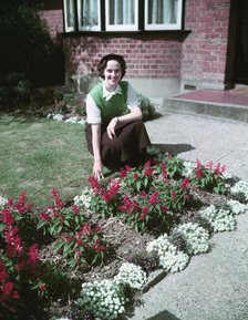 Woman proudly showing off her flower bed, c1955.  Creator: Arthur Charles Kirby Ware.