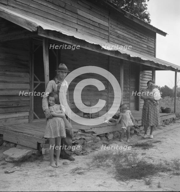 Tobacco sharecropper with his oldest daughter, Person County, North Carolina, 1939. Creator: Dorothea Lange.
