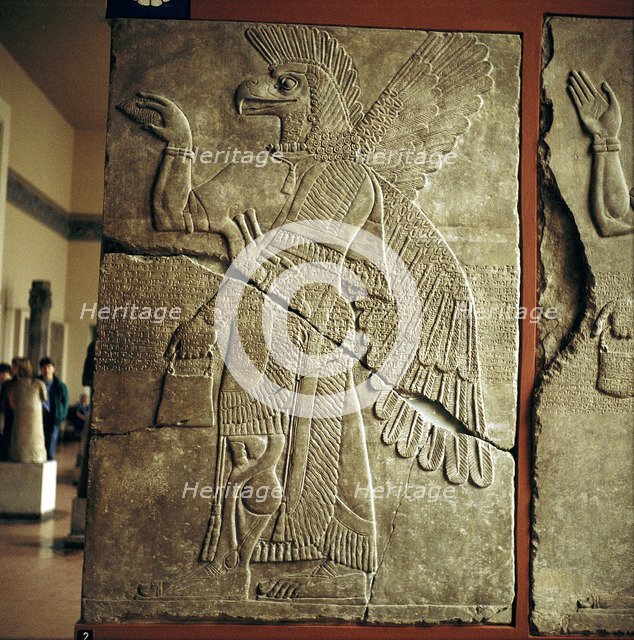 Assyrian relief of Winged genie carrying a cedar-cone. Artist: Unknown