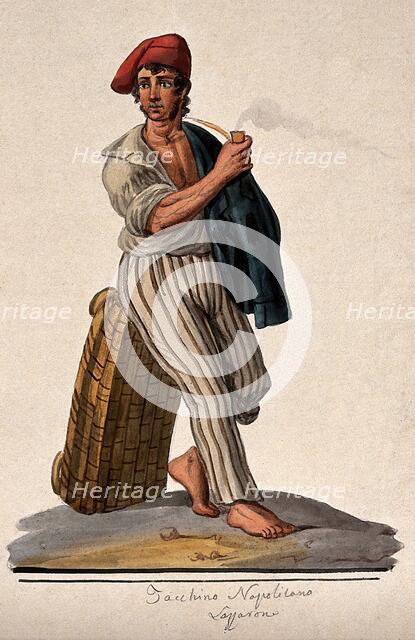 A young man leans against a basket with his jacket slung over his shoulder smoking a pipe. Creator: Unknown.
